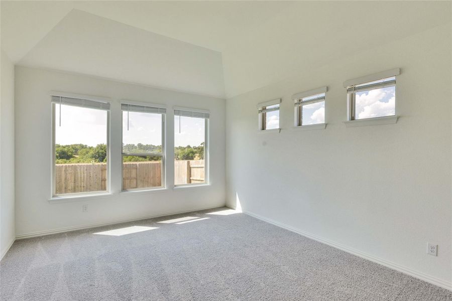Carpeted spare room featuring baseboards