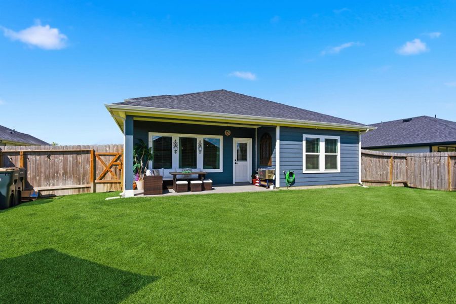 Fully fenced backyard with a covered patio—ideal for outdoor dining or weekend lounging. Fully fenced backyard with a covered patio—ideal for outdoor dining or weekend lounging.