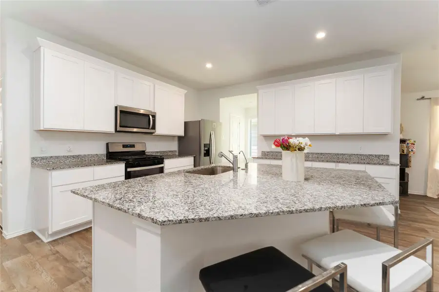 The open layout and bright lighting create a welcoming, functional space for cooking and entertaining. The open layout and bright lighting create a welcoming, functional space for cooking and entertaining.