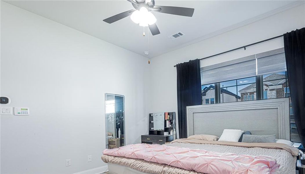 Bedroom featuring ceiling fan and baseboards