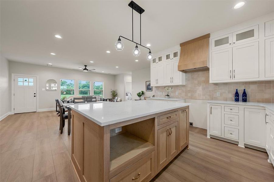 Kitchen island featuring a white countertop and light wood-finish cabinetry