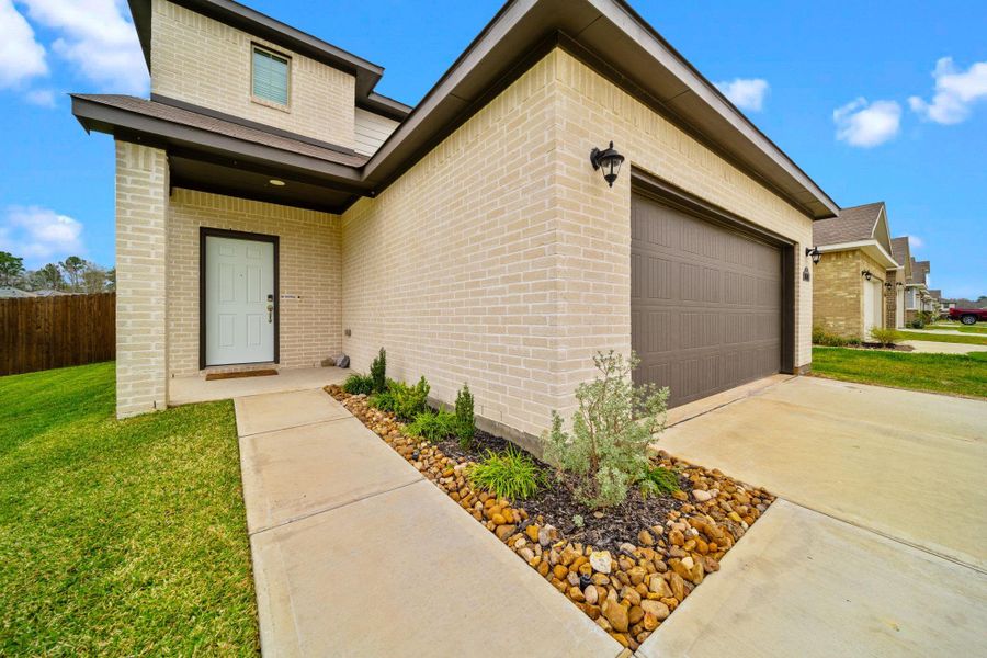 Front exterior of a new home in , Porter, TX, highlighting curb appeal (Image 22). Front exterior of a new home in , Porter, TX, highlighting curb appeal (Image 22).