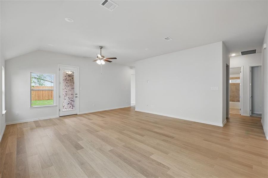 Unfurnished living room with light wood finished floors and a ceiling fan