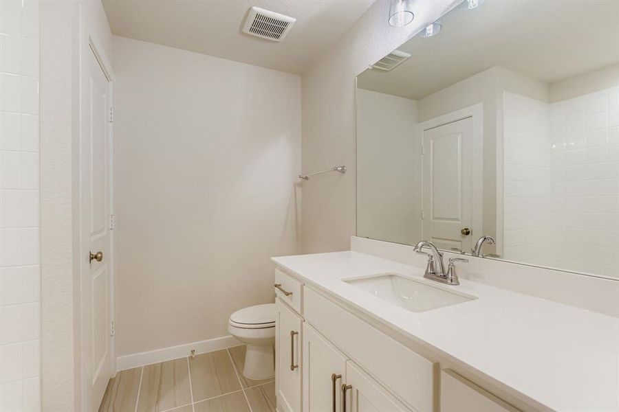 Bathroom with vanity and light tile patterned flooring