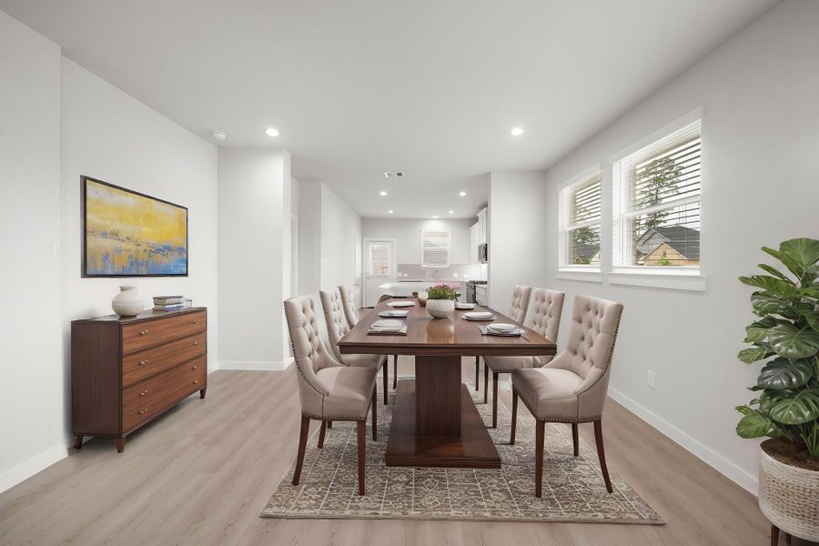 A dining room with a table and chairs.