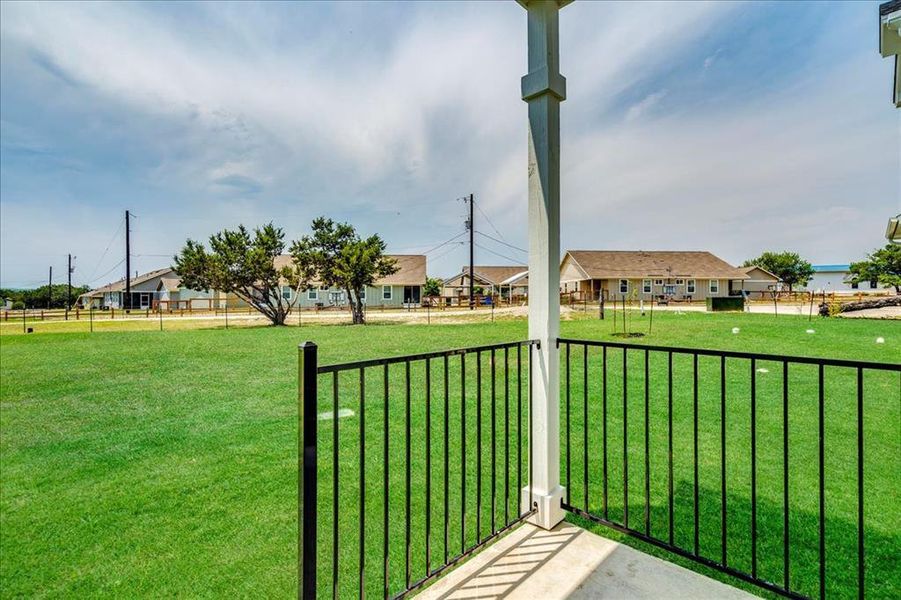 A generous grassy expanse awaits, framed by neighboring homes and mature trees. A generous grassy expanse awaits, framed by neighboring homes and mature trees.