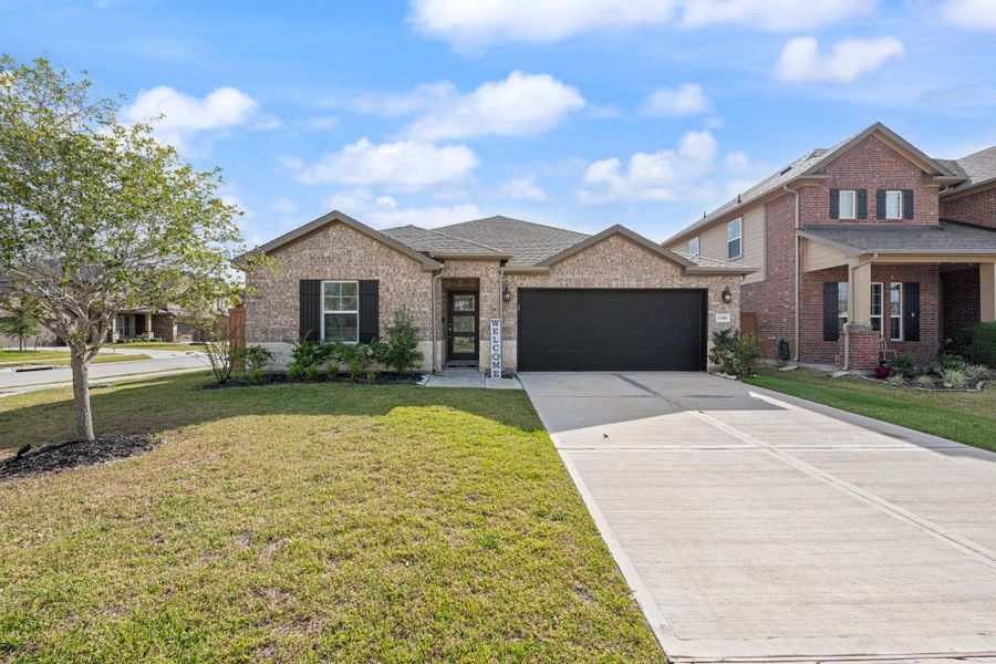 Front exterior of a new home in Sierra Vista, Iowa Colony, TX, highlighting curb appeal (Image 1).
