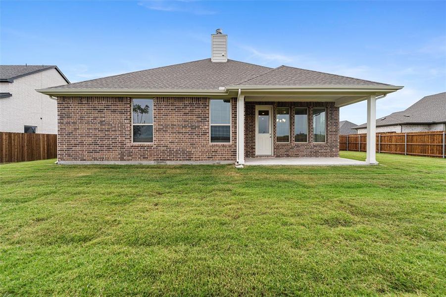 Back of property featuring a fenced backyard, roof with shingles, a patio, and brick siding Back of property featuring a fenced backyard, roof with shingles, a patio, and brick siding