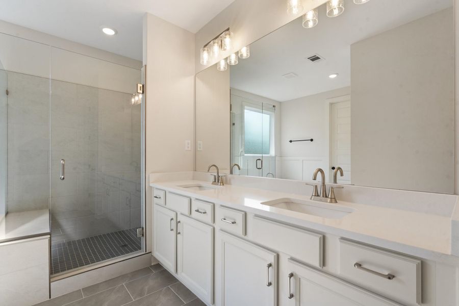 Dual vanity with undermount sinks and light-toned countertops Dual vanity with undermount sinks and light-toned countertops