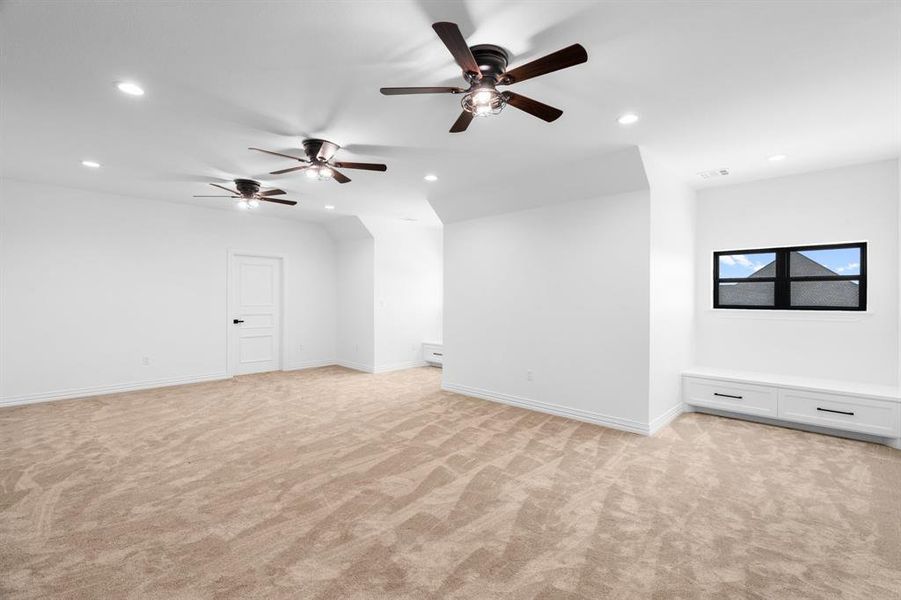 Unfurnished living room with light colored carpet, recessed lighting, and ceiling fan Unfurnished living room with light colored carpet, recessed lighting, and ceiling fan