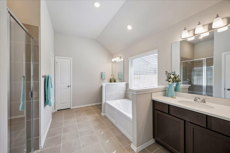 The primary bathroom has dual sink areas, a soaking tub and a separate shower.