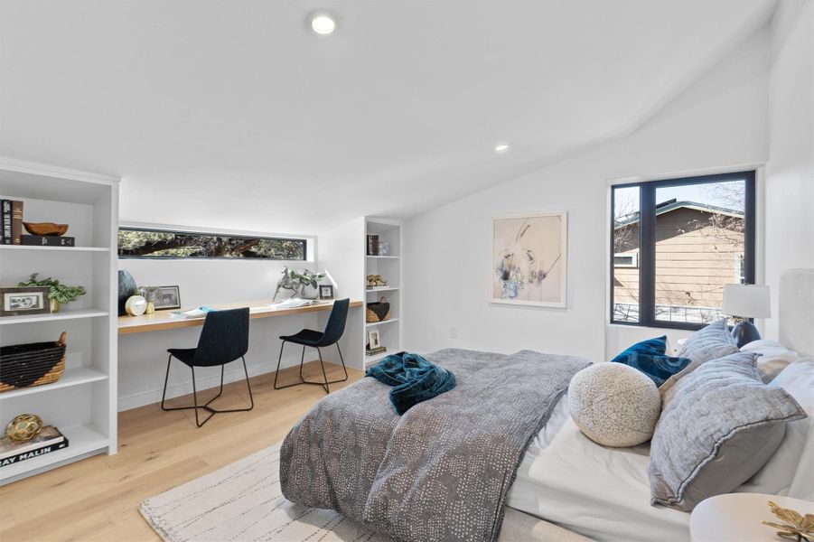 Bedroom featuring a built in desk and shelving