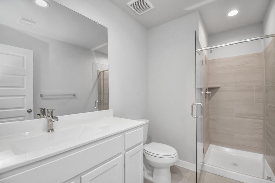 Guest Bathroom with walk-in shower. Sample photo of completed home with similar floor plan. Actual colors and selections may vary.