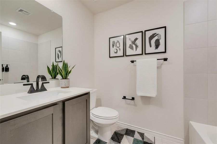 Bathroom with vanity and light tile patterned flooring