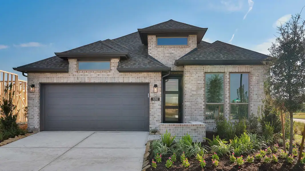 Front exterior of a new home in Bridgeland, Cypress, TX, highlighting curb appeal (Image 1). Front exterior of a new home in Bridgeland, Cypress, TX, highlighting curb appeal (Image 1).