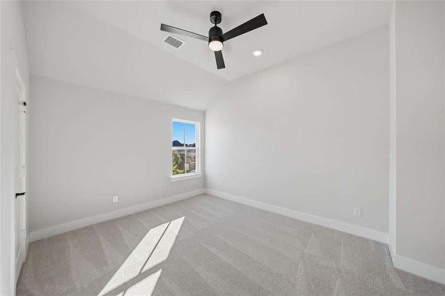 Spare room featuring light carpet, lofted ceiling, a ceiling fan, and recessed lighting