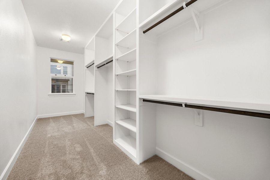 Step into a deeply designed primary closet offering exceptional storage space, smart organization, and room to spare—perfect for keeping your wardrobe effortless and clutter-free. Image depicts similar floorplan in another ROC homes community. Step into a deeply designed primary closet offering exceptional storage space, smart organization, and room to spare—perfect for keeping your wardrobe effortless and clutter-free. Image depicts similar floorplan in another ROC homes community.