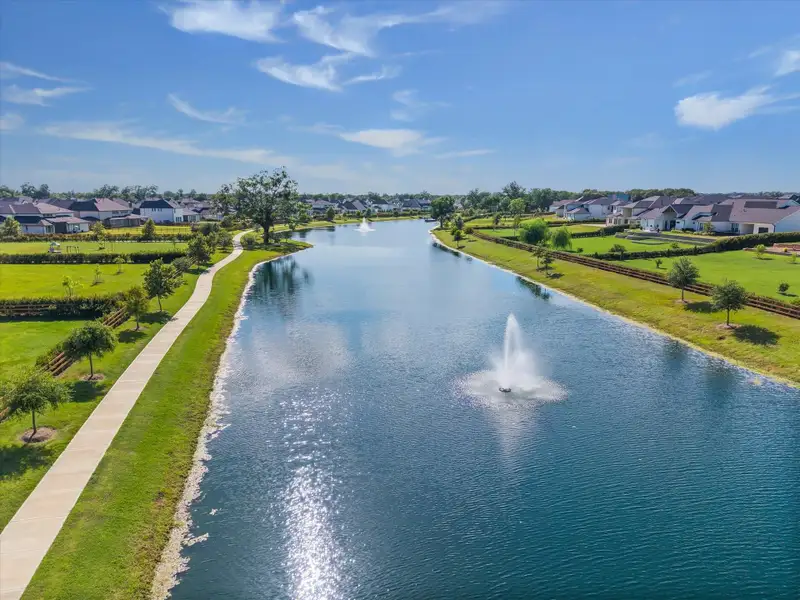 Centered fountain adds a striking focal point while gently circulating the lake, creating movement and sparkle across the water. Sunlight reflecting off the spray enhances the peaceful, resort style atmosphere throughout the community. Centered fountain adds a striking focal point while gently circulating the lake, creating movement and sparkle across the water. Sunlight reflecting off the spray enhances the peaceful, resort style atmosphere throughout the community.