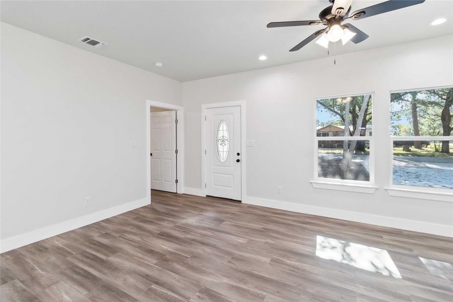 Foyer with recessed lighting, wood finished floors, and ceiling fan