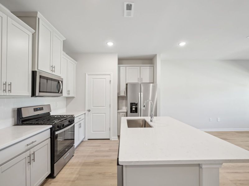 The spacious kitchen island is at the heart of the open-concept first floor.