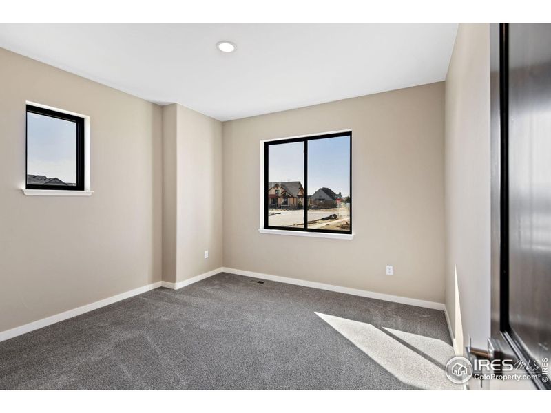 2nd main level bedroom is spacious and includes a walk in closet