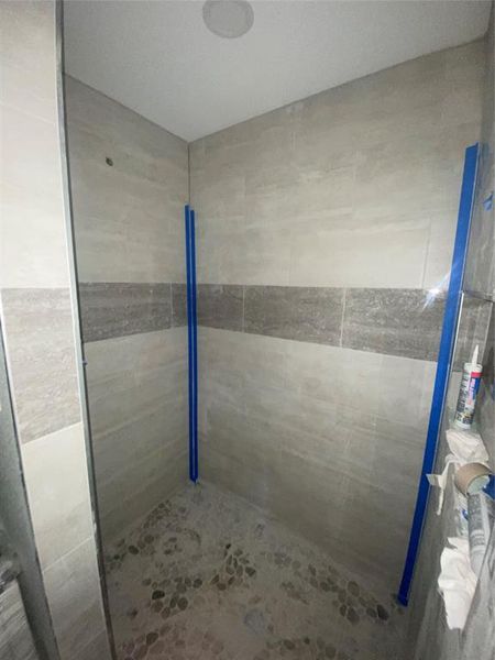 Bathroom with a shower stall Bathroom with a shower stall