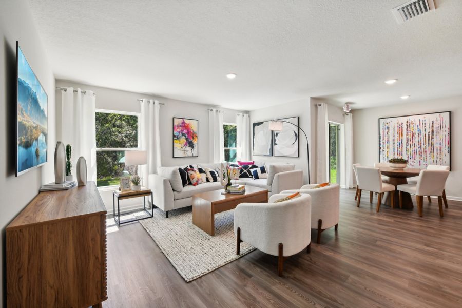 A living room with a large rug.
