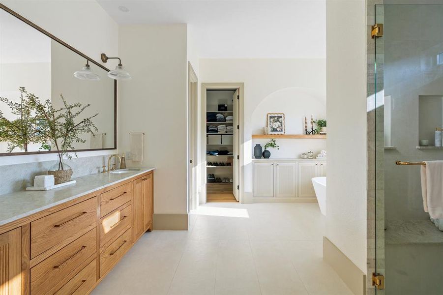 Bathroom featuring dual bowl vanity, independent shower and bath, and tile floors