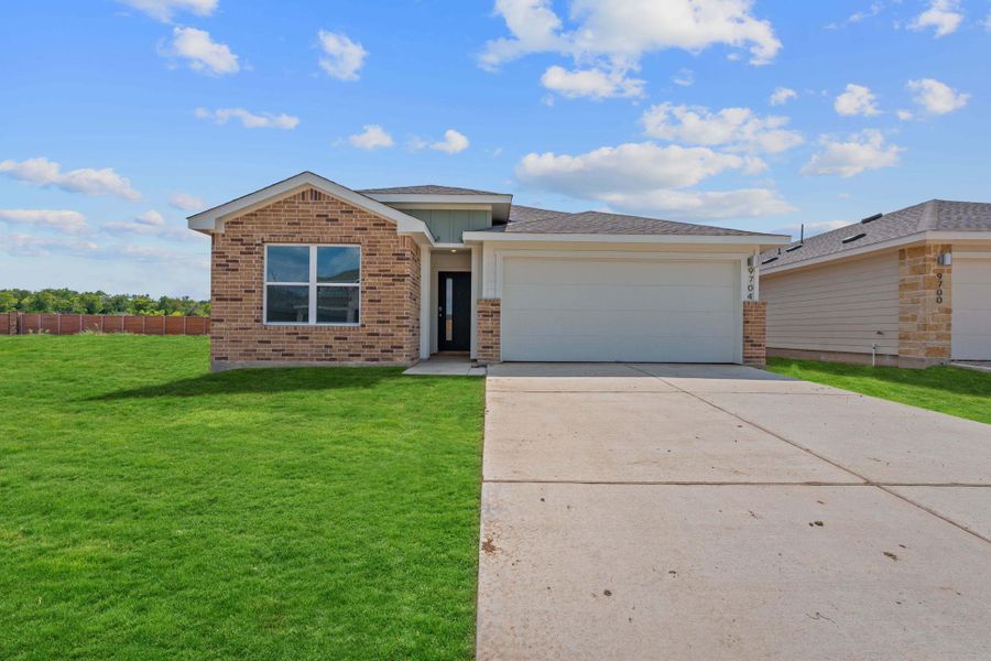 View of front facade featuring brick siding, an attached garage, driveway, and a shingled roof View of front facade featuring brick siding, an attached garage, driveway, and a shingled roof