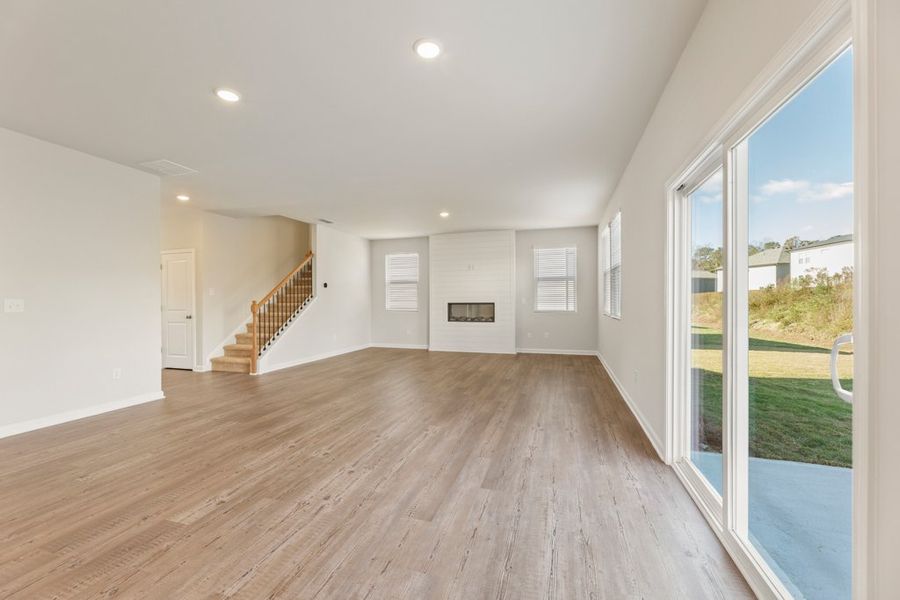 A large room with a wood floor and a large glass door. A large room with a wood floor and a large glass door.