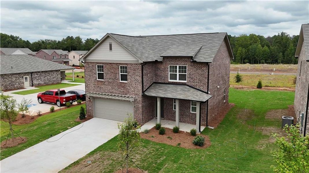 Front exterior of a new home in Kendall Grove, McDonough, GA, highlighting curb appeal (Image 2). Front exterior of a new home in Kendall Grove, McDonough, GA, highlighting curb appeal (Image 2).