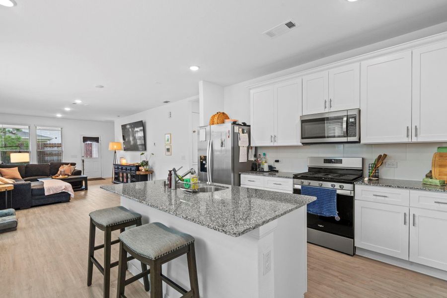 Gorgeous open kitchen over looking the living room. Gorgeous open kitchen over looking the living room.