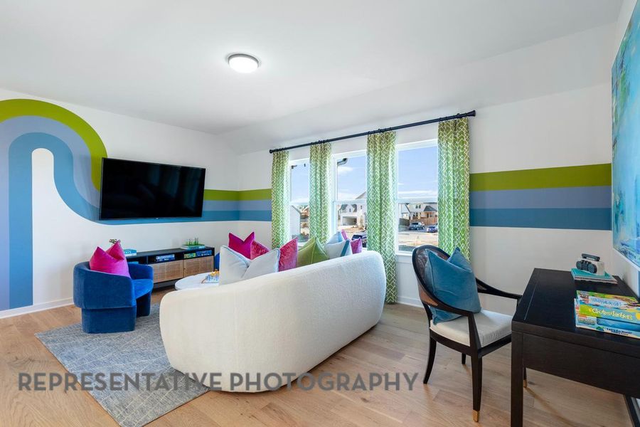Living room with wood finished floors and vaulted ceiling Living room with wood finished floors and vaulted ceiling