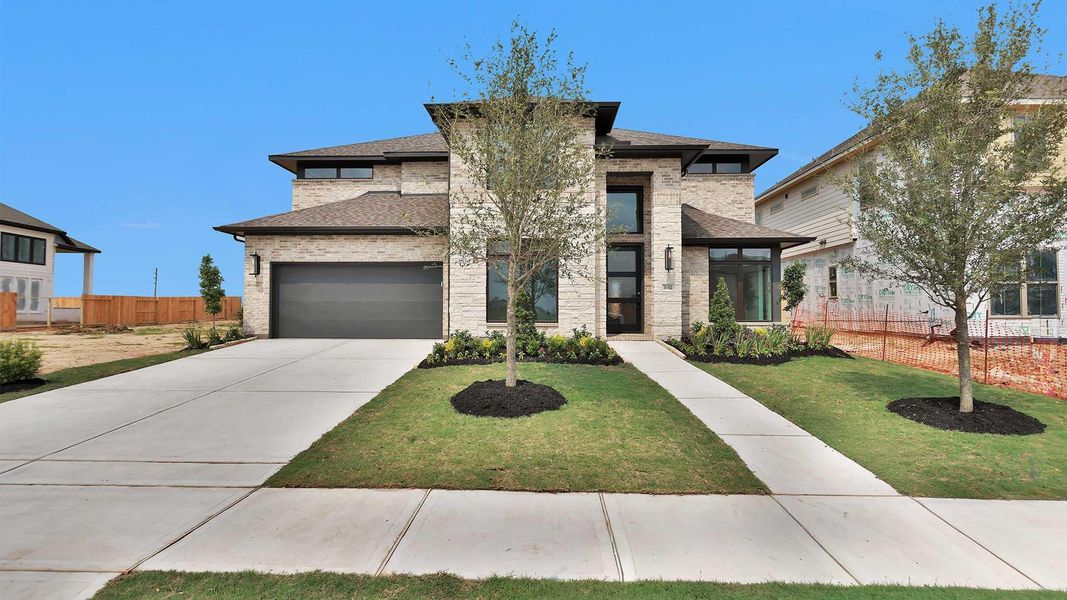 Front exterior of a new home in Candela, Richmond, TX, highlighting curb appeal (Image 2).