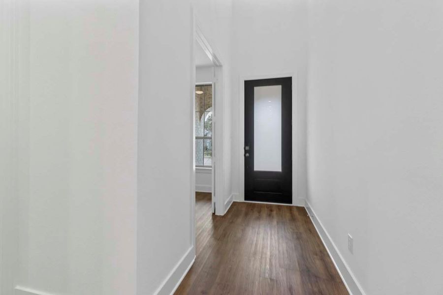 Foyer entrance with dark wood-style floors and baseboards Foyer entrance with dark wood-style floors and baseboards