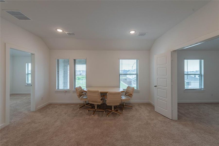Unfurnished bedroom with light colored carpet, recessed lighting, baseboards, and ensuite bath