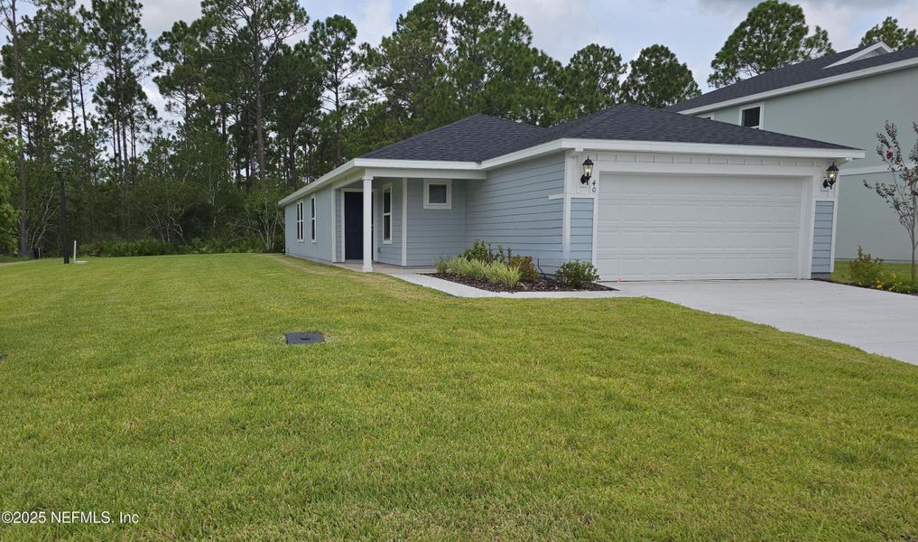 Front exterior of a new home in Flagler Village - Classic Series, Palm Coast, FL, highlighting curb appeal (Image 1). Front exterior of a new home in Flagler Village - Classic Series, Palm Coast, FL, highlighting curb appeal (Image 1).