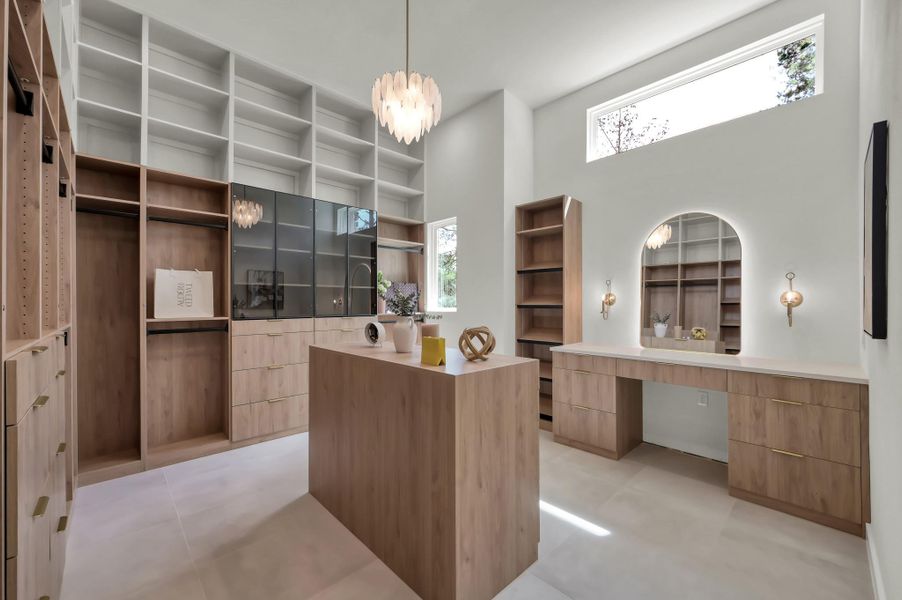 Primary closet includes a built in vanity area for getting ready.