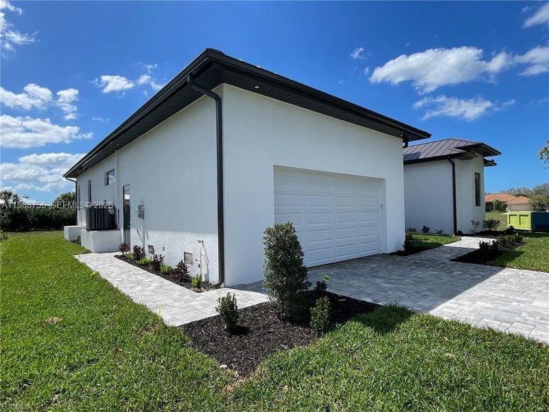 Front exterior of a new home in , Punta Gorda, FL, highlighting curb appeal (Image 15).