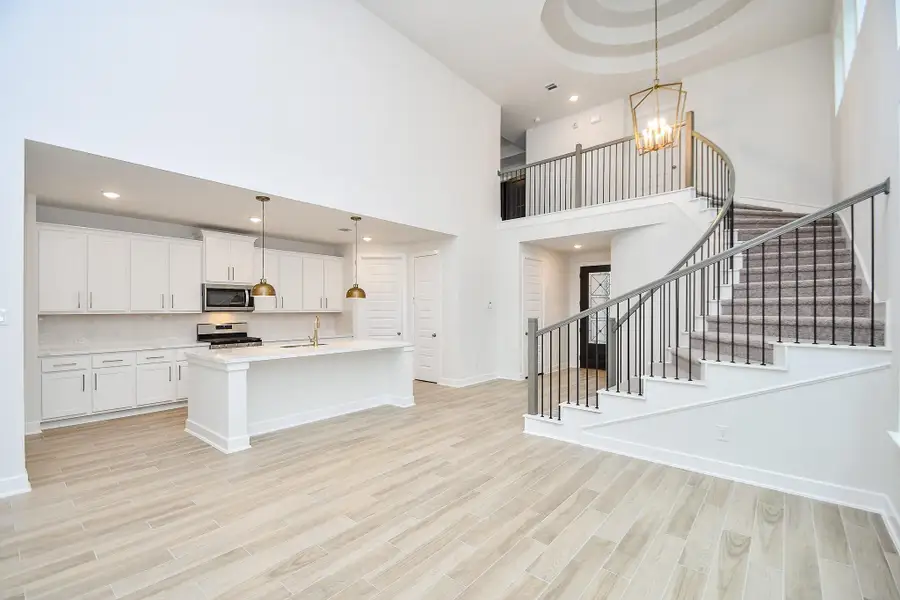 A bright dining or living area with large windows and beautiful wood flooring.
