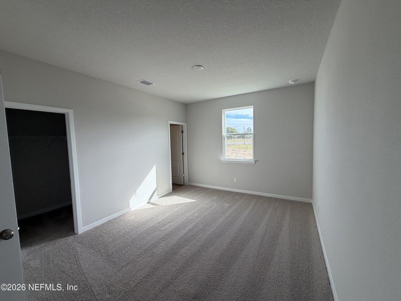 Spacious, unfurnished interior of a new home in The Cypress Series at Reserve East, Flagler Beach (Image 14).