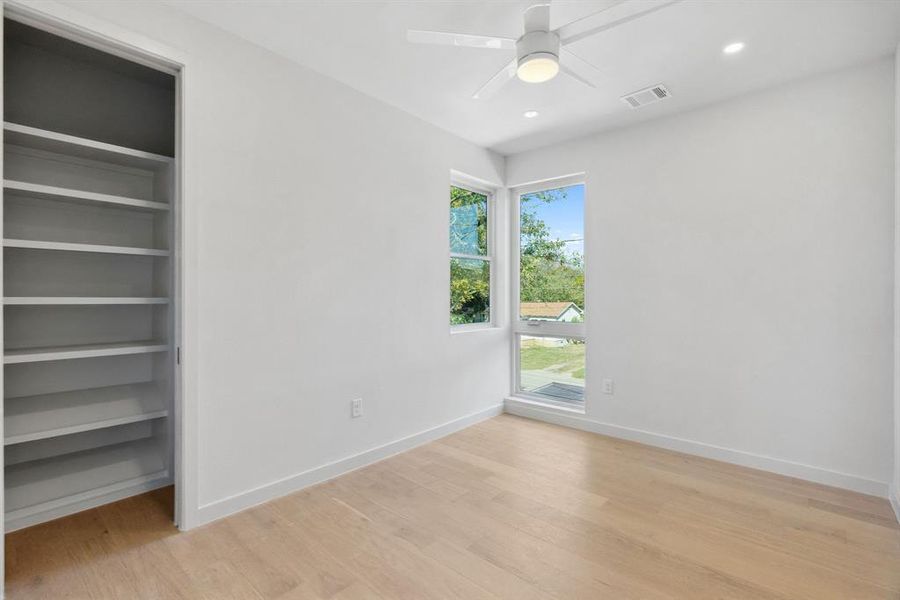 Unfurnished bedroom featuring light wood-type flooring, ceiling fan, recessed lighting, and a closet