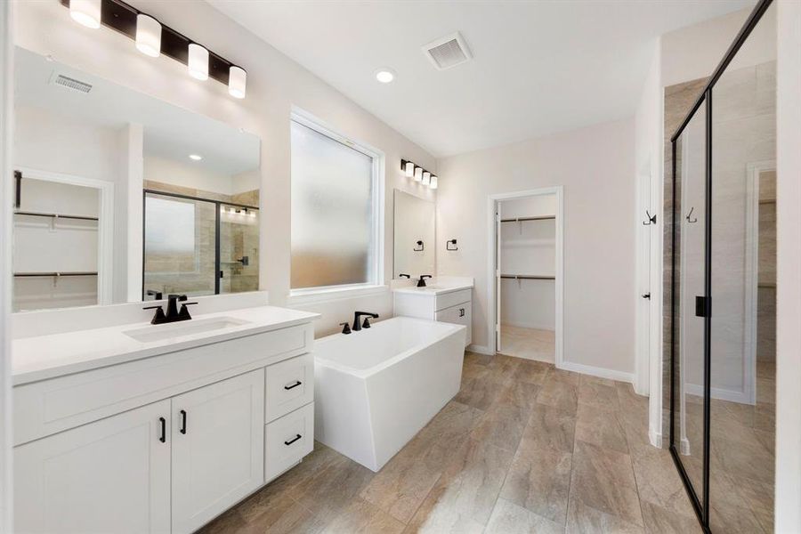 Featuring dual vanities, soaking tub, spacious walk in shower and his & her closets, you'll fend everything you have been searching for in this dream owner's bath!