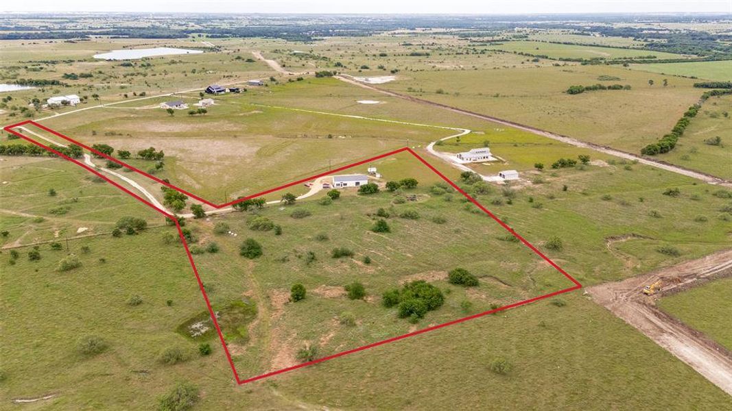 Expansive parcel featuring a rural landscape, existing residential structures, and natural terrain Expansive parcel featuring a rural landscape, existing residential structures, and natural terrain