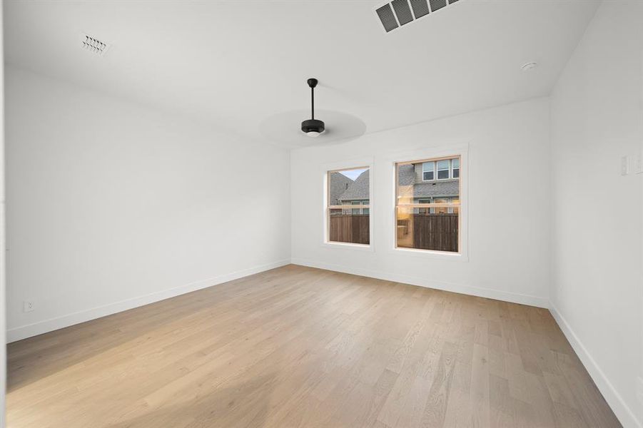 Unfurnished room with light wood finished floors and baseboards