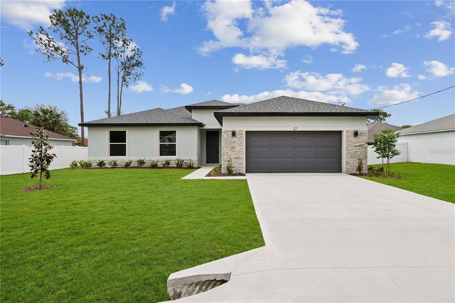 Front exterior of a new home in Palm Coast, Palm Coast, FL, highlighting curb appeal (Image 2). Front exterior of a new home in Palm Coast, Palm Coast, FL, highlighting curb appeal (Image 2).