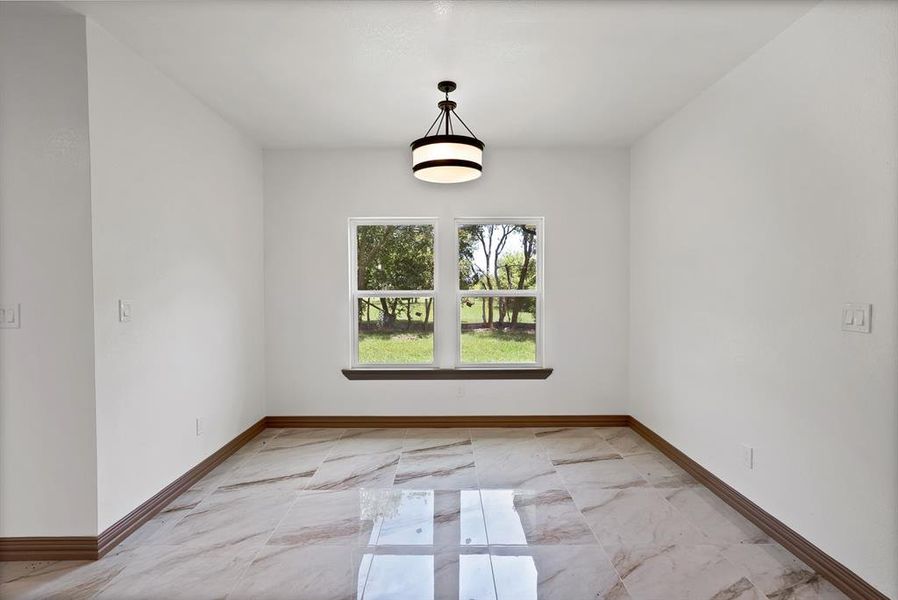 Empty room with light marble finish floors and baseboards