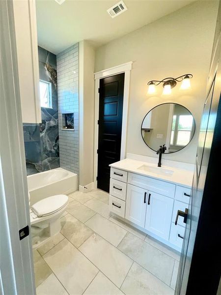Third bath featuring vanity and shower / bath combination