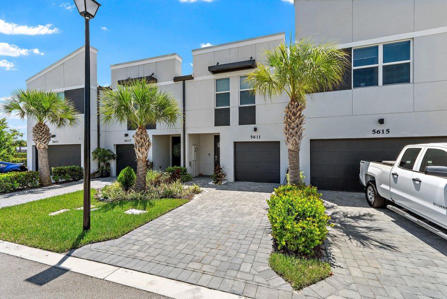 Front exterior of a new home in Enclave at Mangonia Park, West Palm Beach, FL, highlighting curb appeal (Image 23).