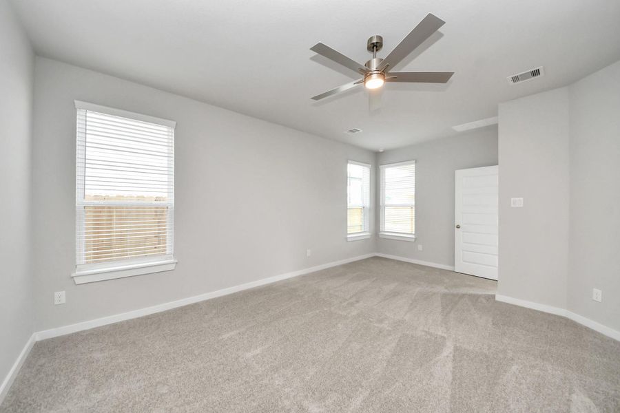 Escape and relax in the exquisite primary suite, a haven to unwind after a long day. The spacious room, boasts plush carpeting, soothing paint tones, high ceilings, and expansive windows adorned with privacy blinds.